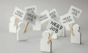 Figurki ludzi z transparentami "NEED JOB" i "NEED WORK". Dowiedz się, jak sprawdzić status bezrobotnego online.